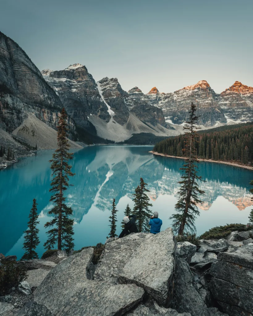 View of Moraine Lake with mountains and pine trees in Banff National Park, Canada.